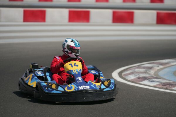 Documentário Inédito Revela Lado B de Ayrton Senna A go-kart racer in red suit speeds on Yas Marina Circuit in Abu Dhabi.