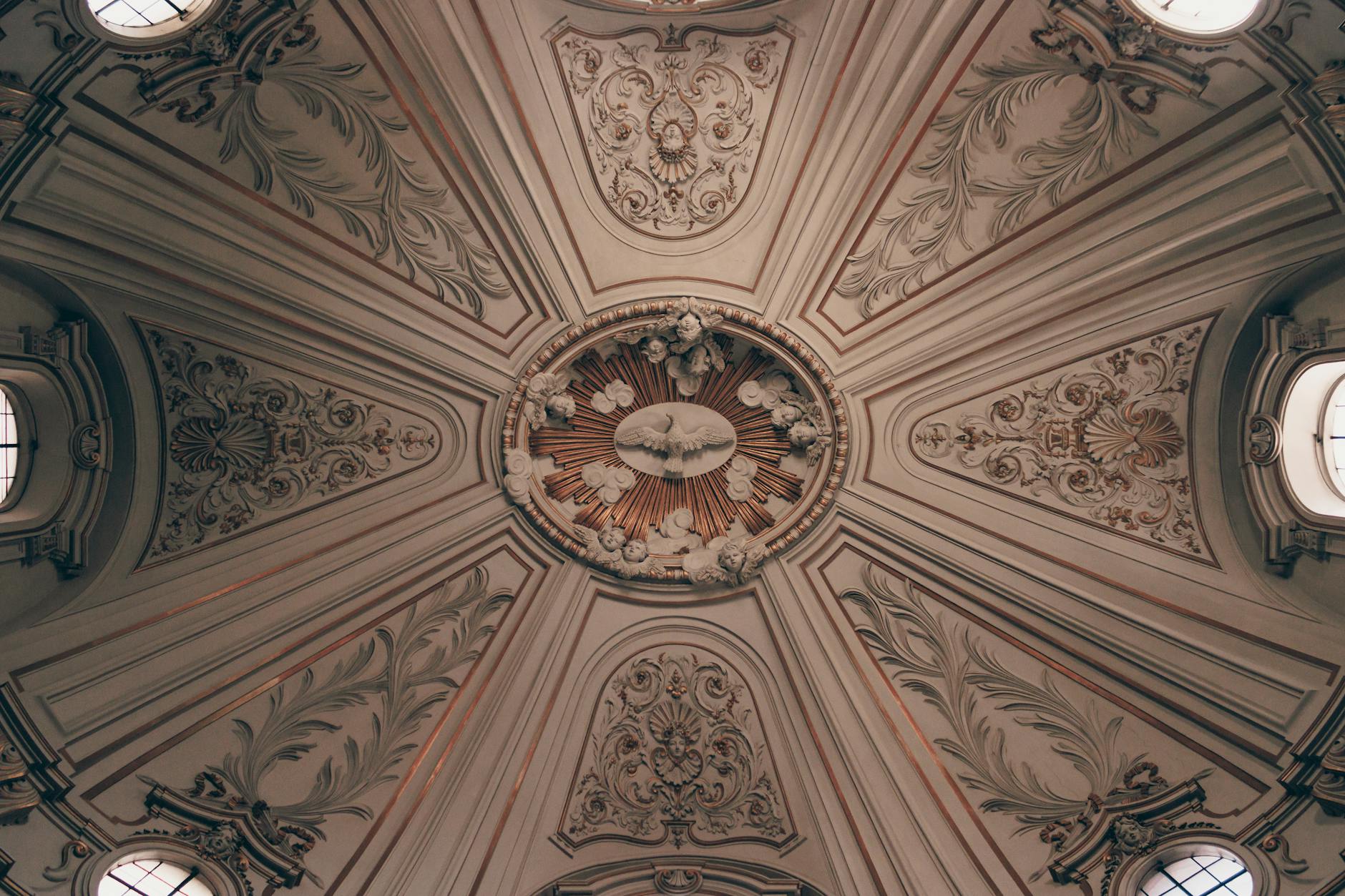 Ornate baroque ceiling design inside Santi Celso e Giuliano church, Rome, Italy.