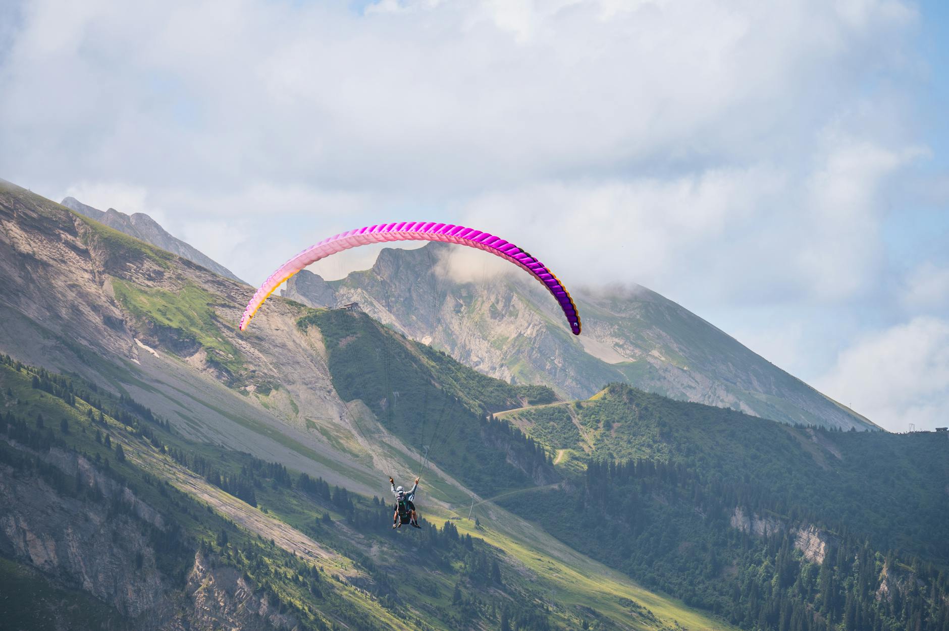 Experience thrilling paragliding over stunning mountain landscapes, perfect for adventure seekers.