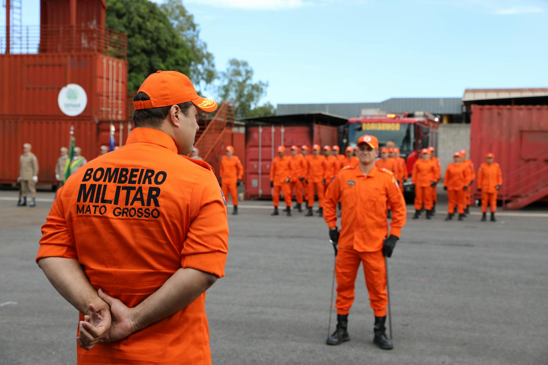 Uniformed firefighters of Mato Grosso in formation for training exercise outdoors.