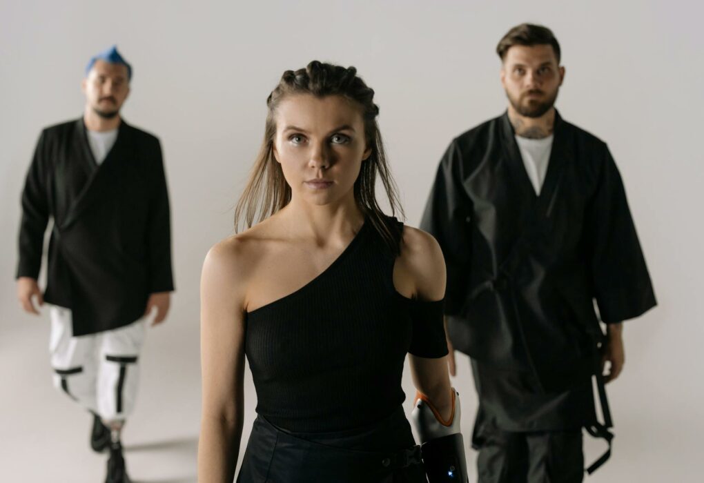 Diverse group showcasing fashion and prosthetic technology in a modern studio setting.