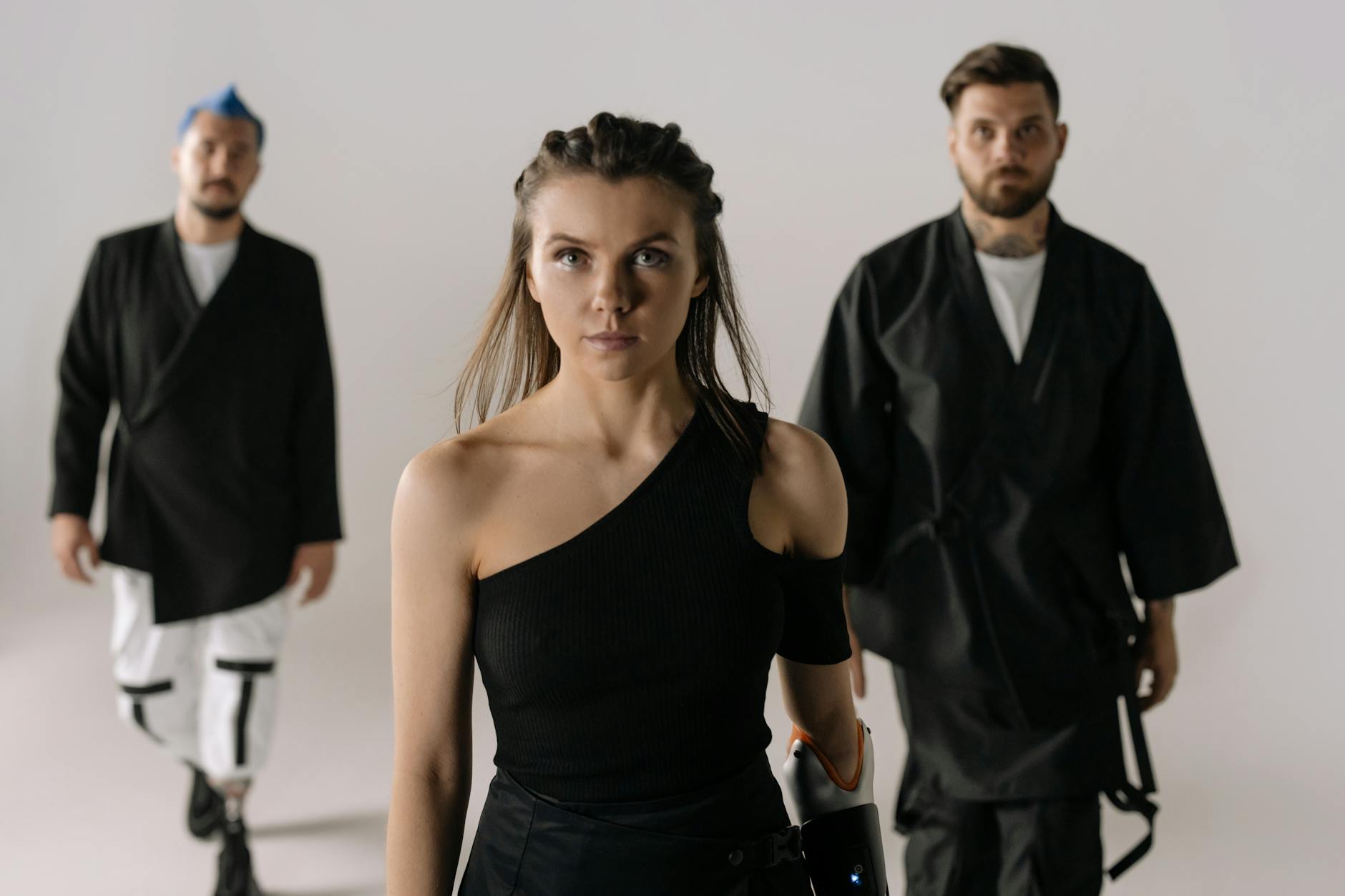 Diverse group showcasing fashion and prosthetic technology in a modern studio setting.