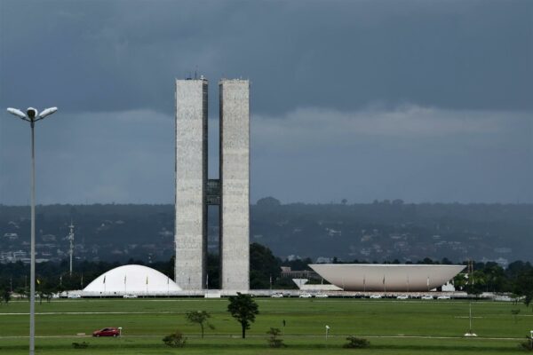 Universidades Federais: Cotas Abalam Teses de Fraude View of the Brazilian National Congress showcasing its iconic modernist architecture.