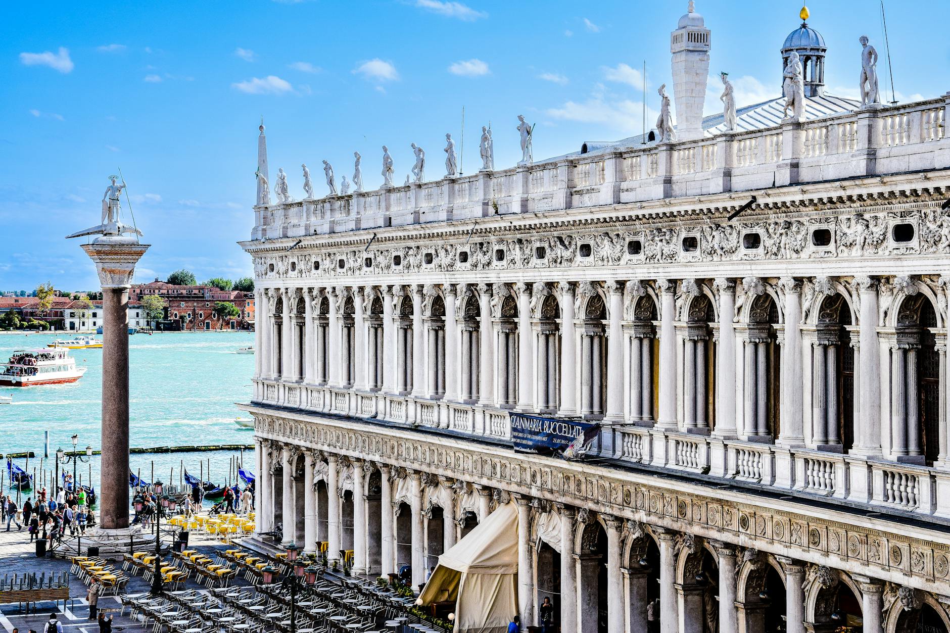 View of Biblioteca Marciana in Venice beside the Grand Canal, showcasing stunning architecture on a sunny day.