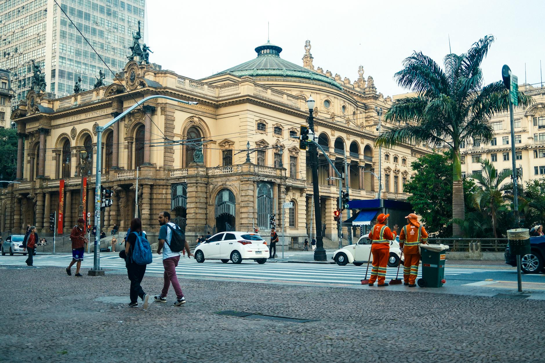 Street view of São Paulo Municipal Theatre with pedestrians and workers in Sao Paulo.