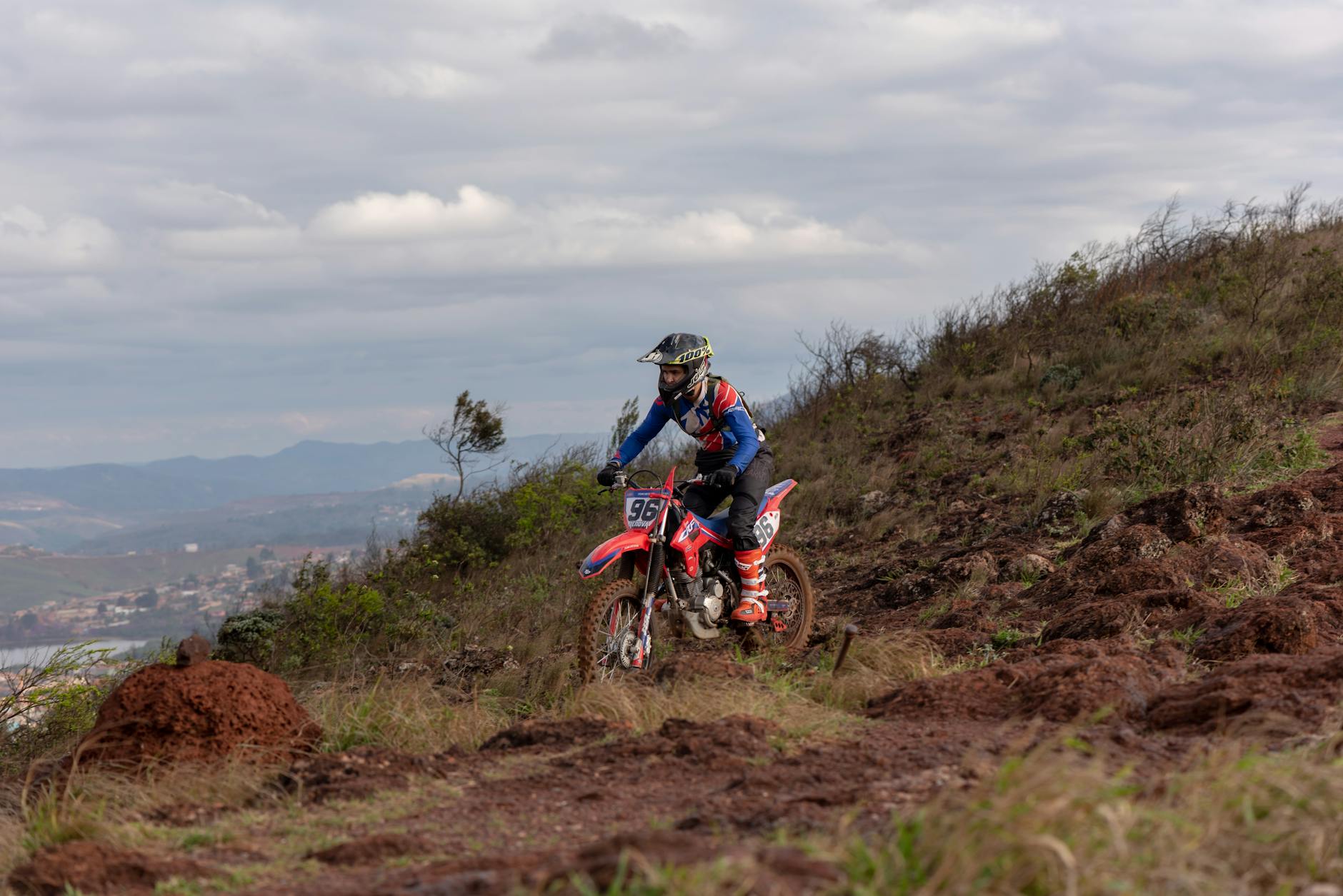 Dynamic shot of a motocross rider navigating rugged terrain in Minas Gerais, Brasil, showcasing extreme sport action.