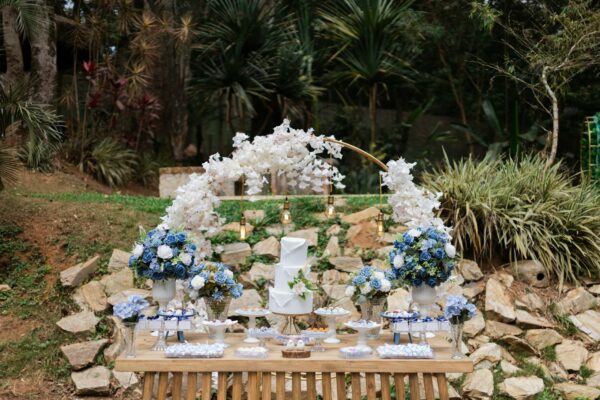 Novo Centro de Triagem de Lixo Impulsiona Reciclagem em SP Outdoor dessert table with blue and white floral decor set in São Paulo, perfect for weddings or celebrations.