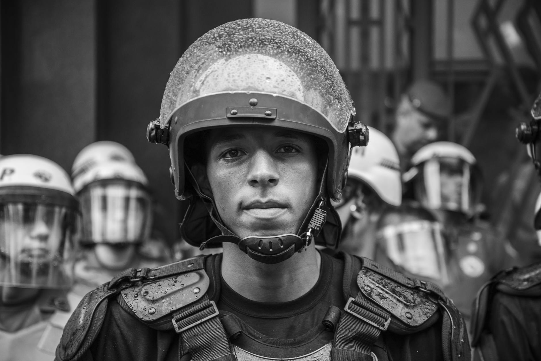 Close-up grayscale portrait of a riot police officer in Sao Paulo, Brazil.