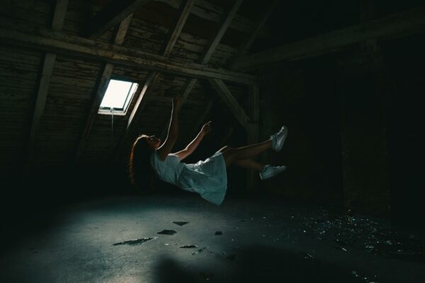 Amazônia: Estudo Inédito Revela Aceleração do Desmatamento Urbano A surreal photograph of a woman in a white dress floating in an abandoned attic, capturing a sense of mystery.